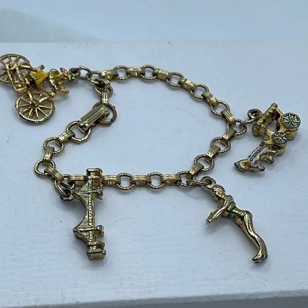 Vintage 6” charm bracelet. Gold tone with crossover clasp.